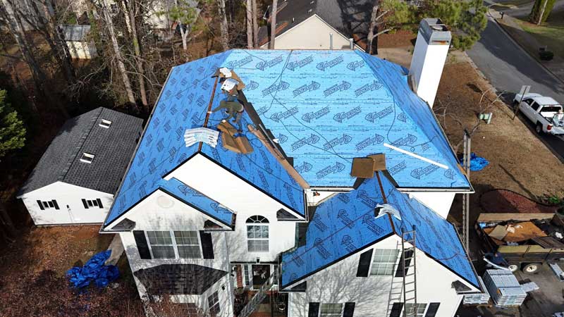 Synthetic Underlayment Is Being Installed On A Residential Roof Prior To Asphalt Shingles Going On The Roof